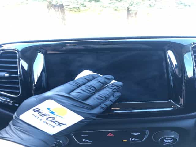Black glove sanitizing car monitor.2109211357570