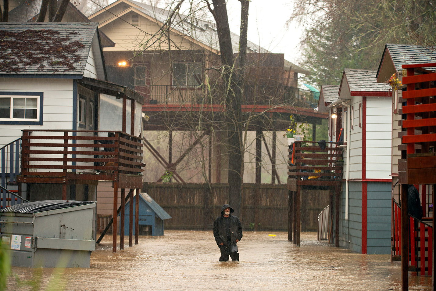 a flooded neighborhood with trees and houses