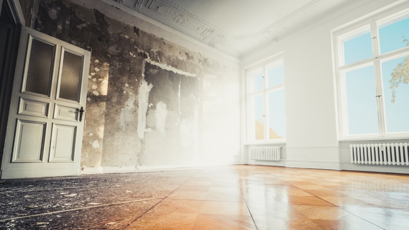 An edited image of a room half affected by fire damage and the other half unaffected.