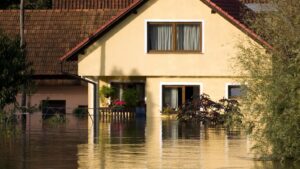 An outside view of a home that is flooded by about three feet of water.