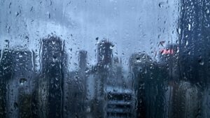 A city scape through a rain-covered window.