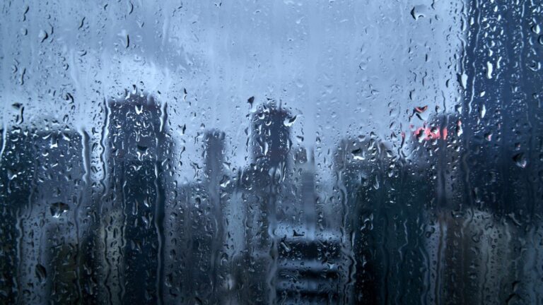 A city scape through a rain-covered window.
