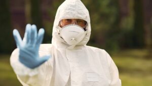A biohazard restoration specialist wears full PPE gear.