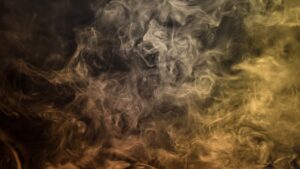 A black background with thick curling smoke across it.