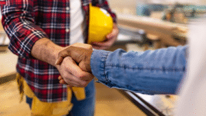 restoration expert and city official shake hands over a project plan.