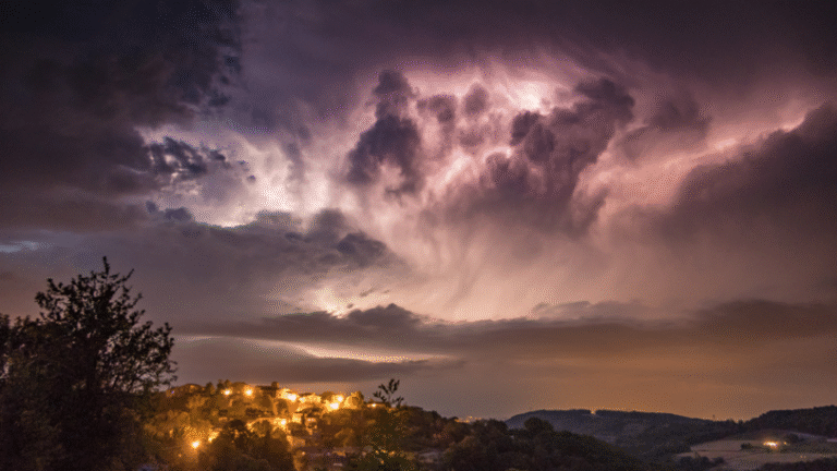 A hillside community under a dark sky after a large storm.