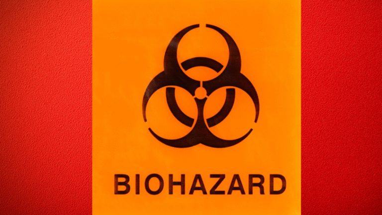 Close-up image of a red barrel with a large, orange biohazard sign and symbol